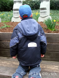 Child with a lost parents sticker on his back (previously stickers, now wristbands)